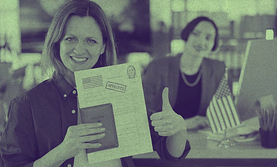 A person golding a document with the approved stamp.