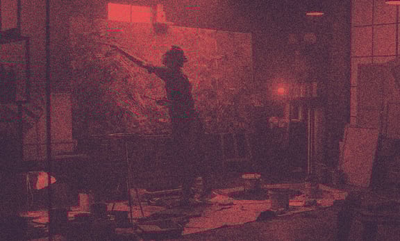 A painter paints a wide canvas.