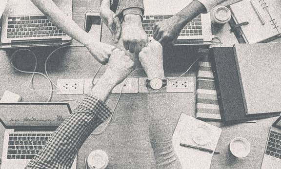 Several people fisting together.