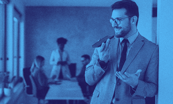 A man in suit with the UK innovator founder visa talking on his phone.