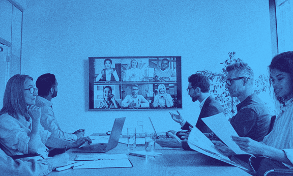 A group of people with the UK scale-up visa working in an office space.