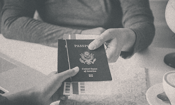 A person receiving his passport from some other person.