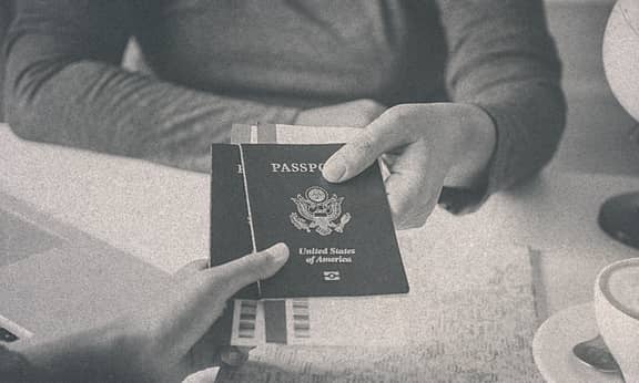 A person receiving his passport from some other person.